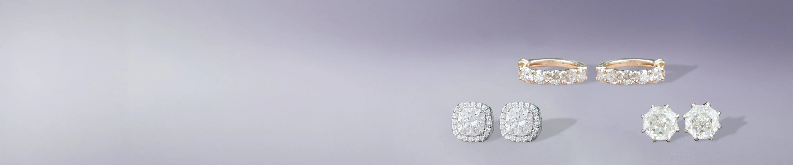 Moissanite stud earrings in round and princess cut stone displayed on a soft fabric background