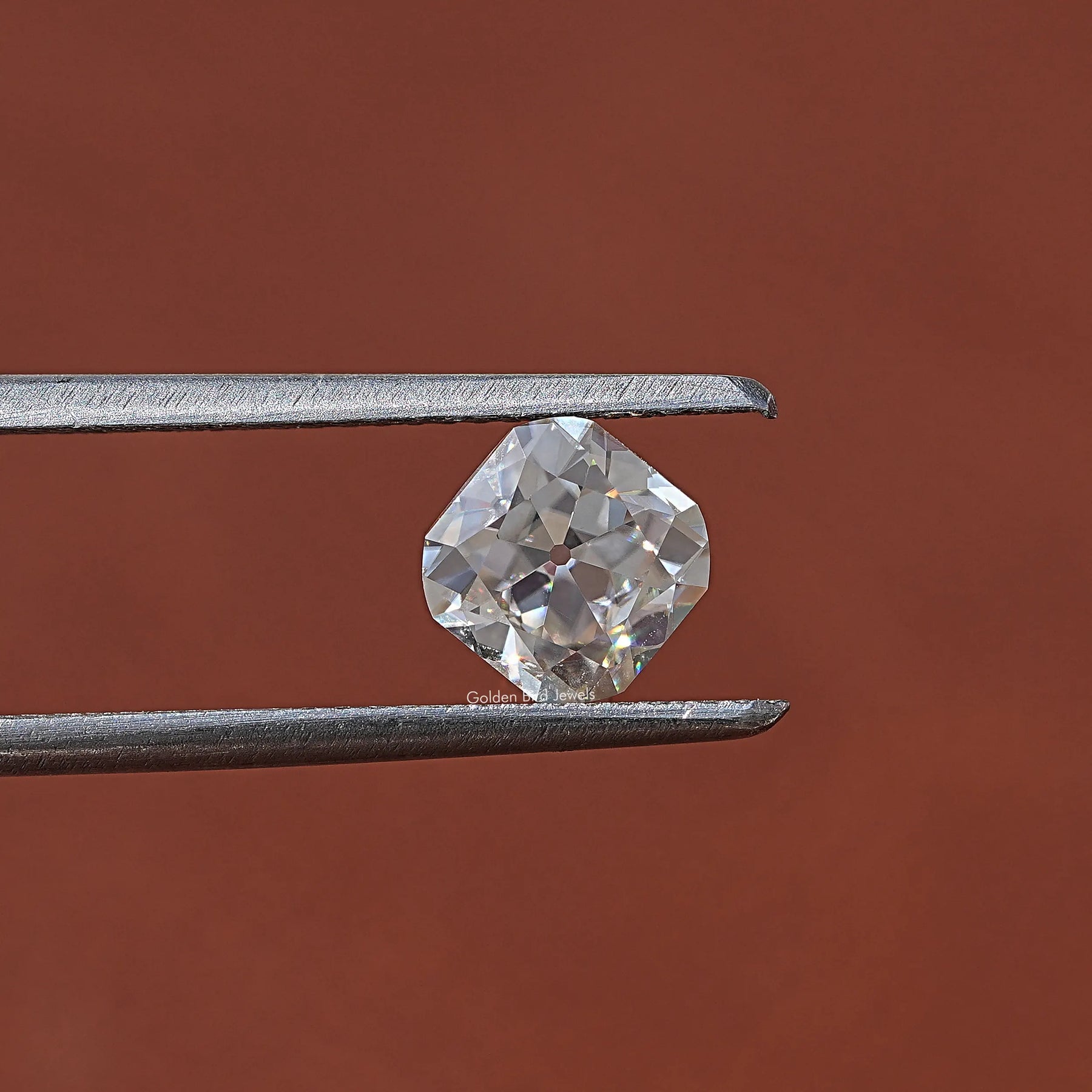 Twijer hold in the Old Mine Cushion Cut Loose Moissanite In White Gold