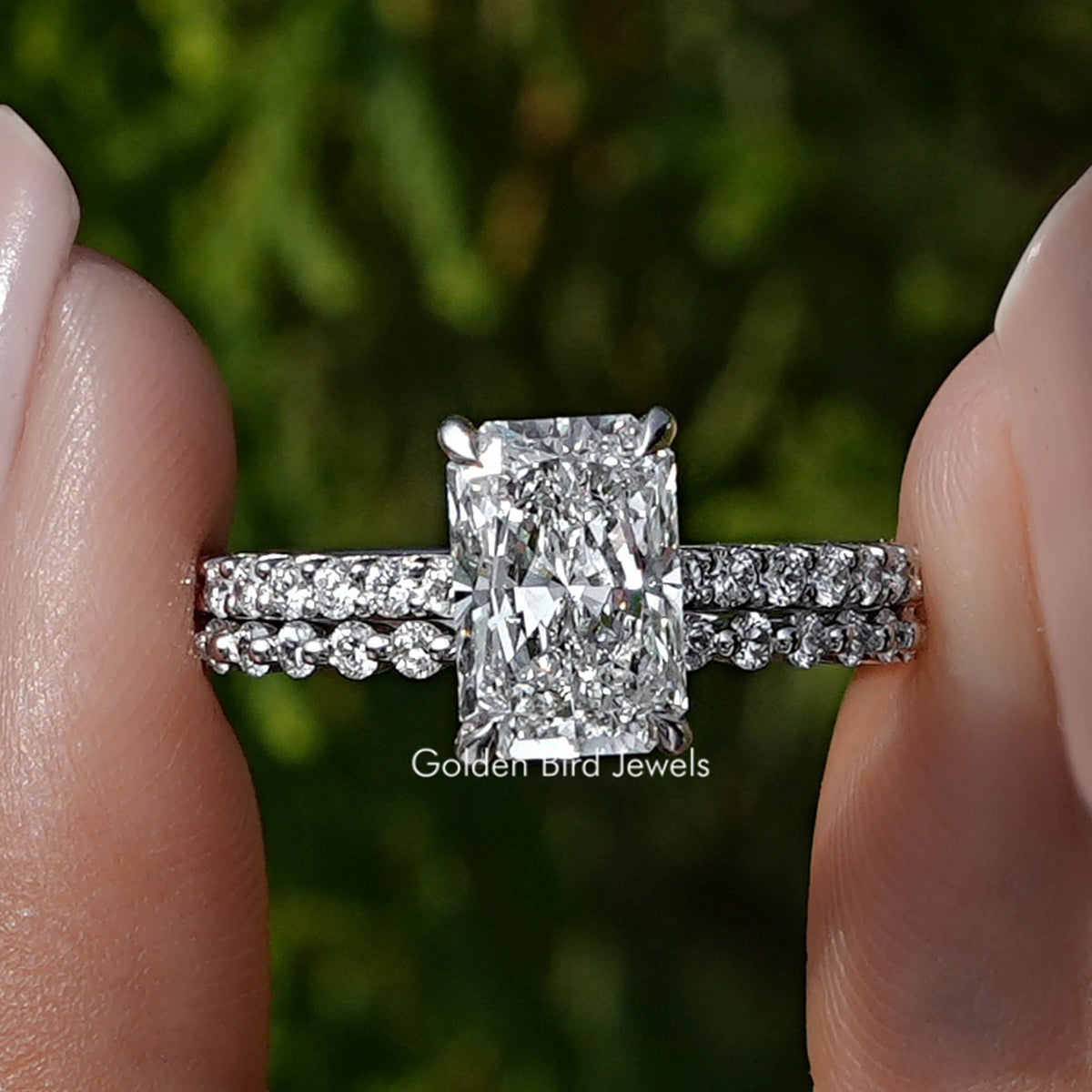 Radiant Cut Diamond Bridal Ring Set Held Between Fingers