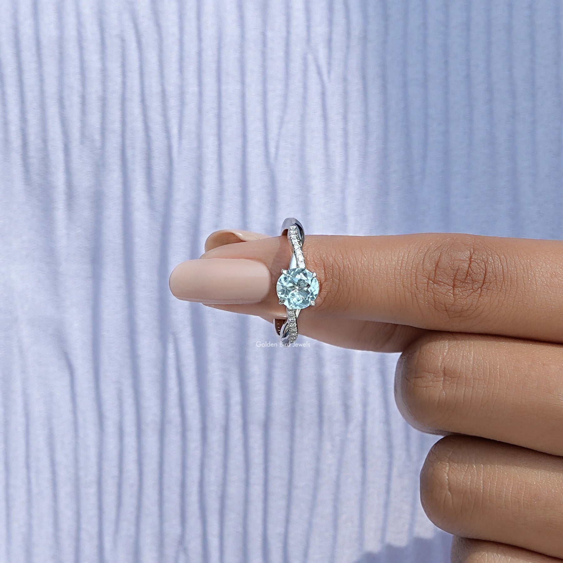 In finger front View of Round Cut Gemstone Accent Ring In White Gold