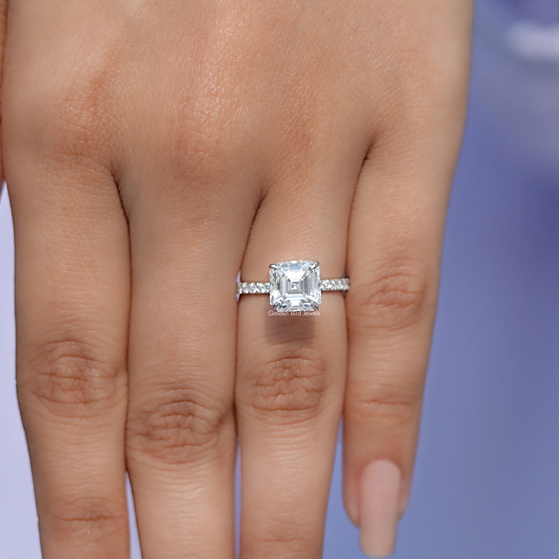 In front finger View Of Solitaire Moissanite Ring In Asscher Accent Ring