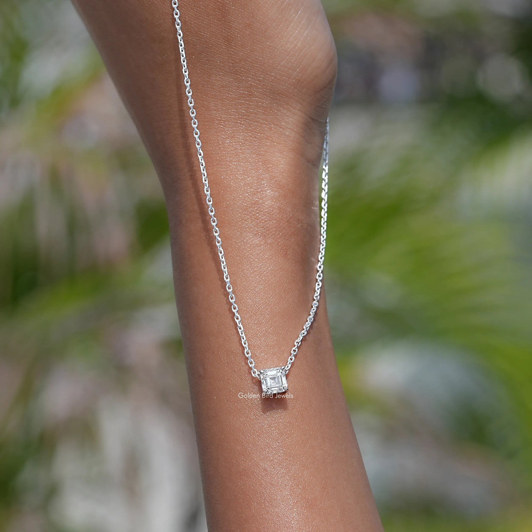 In hand showing view of diamond pendant in secure setting