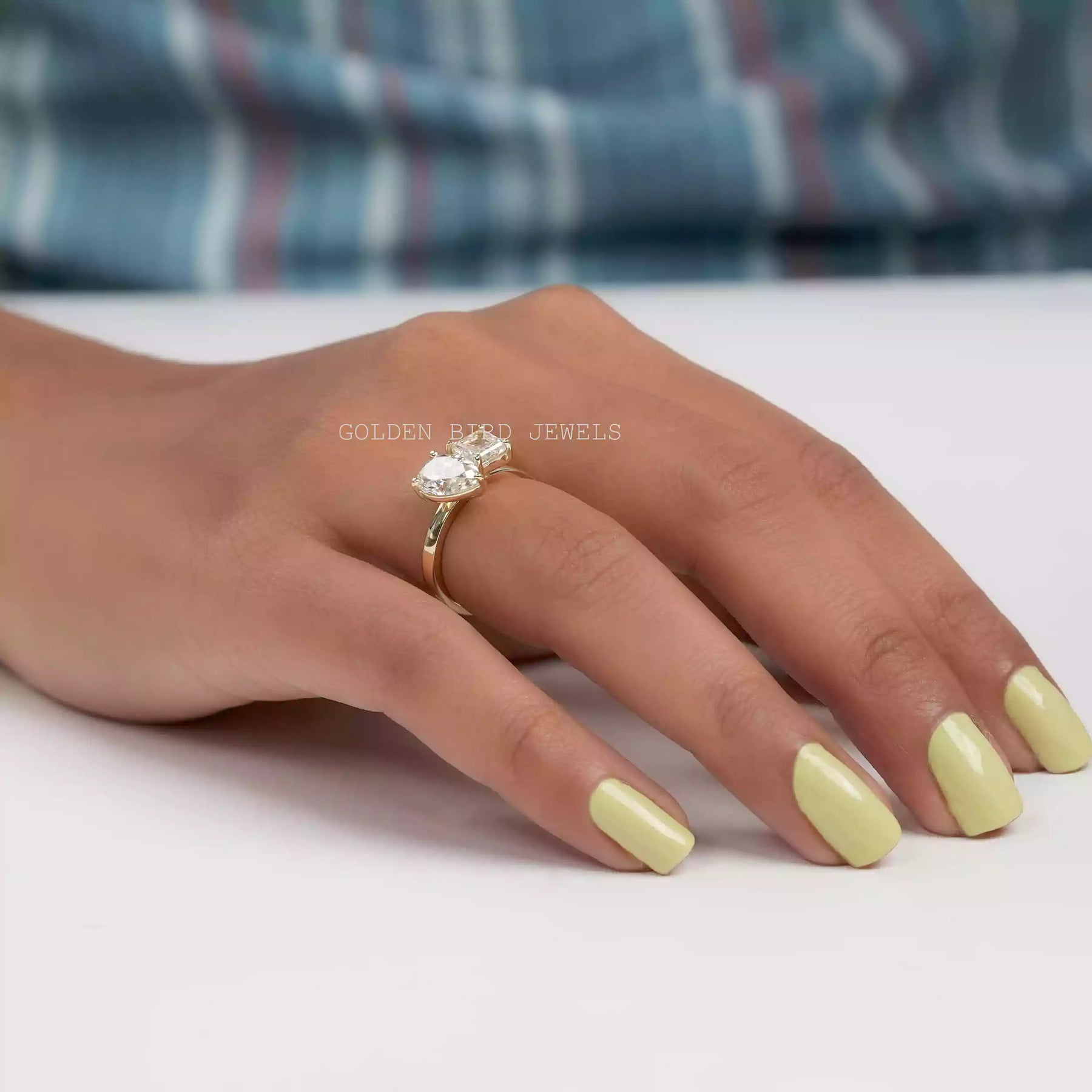 In finger close view of Toi et Moi double halo engagement ring