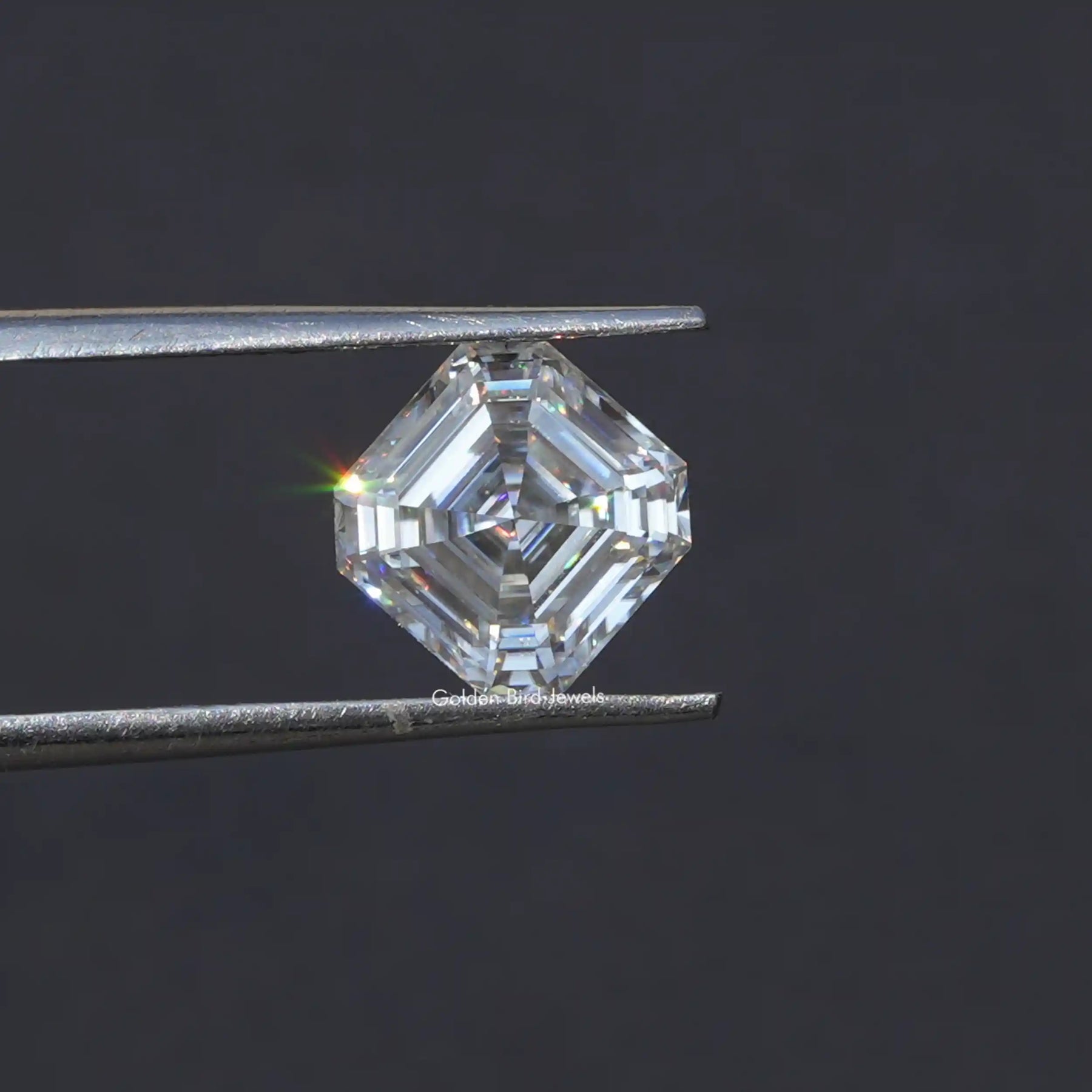 Tweezer holding the Moissanite Asscher Cut Loose Stone