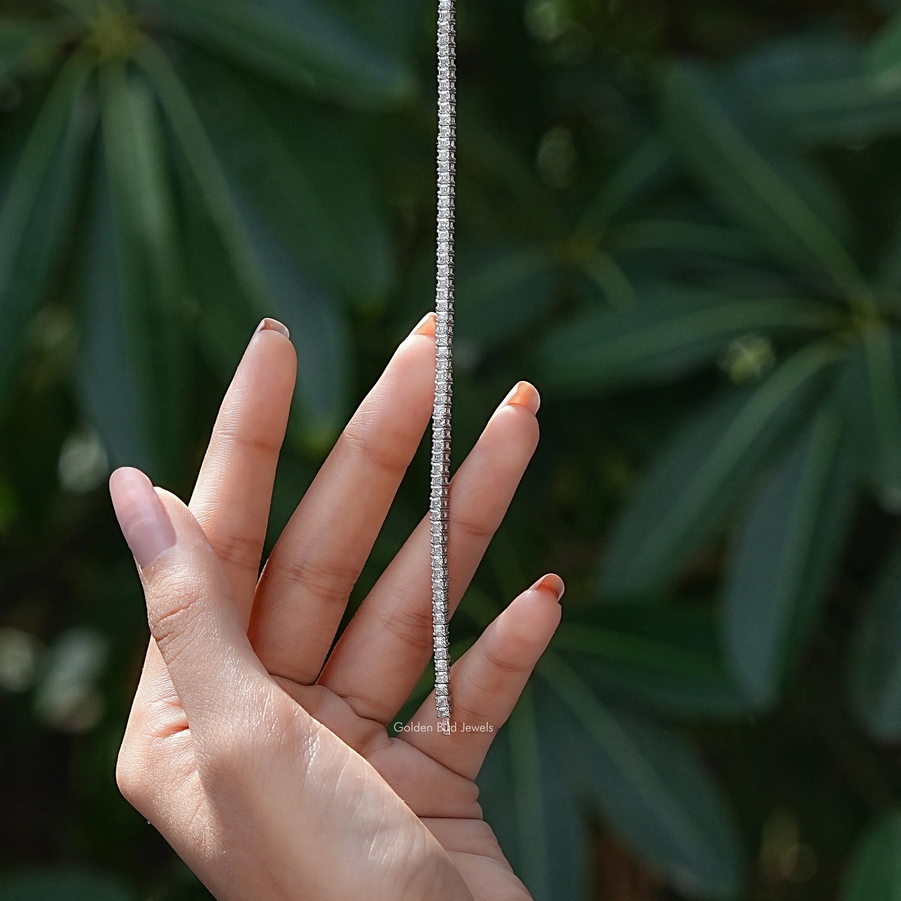 In hand view of asscher moissanite halo bracelet