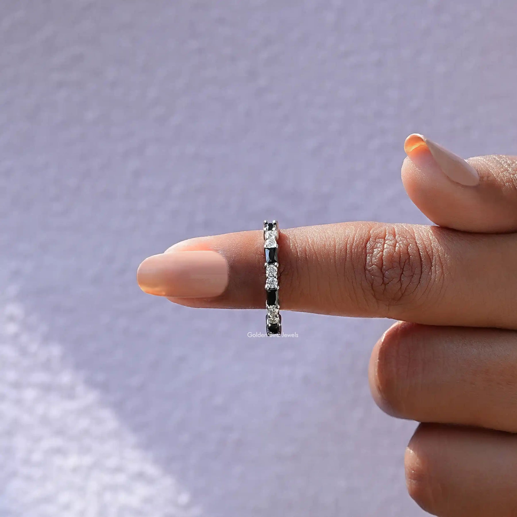 In finger front View of Baguette And Round Cut Eternity Band In White Gold