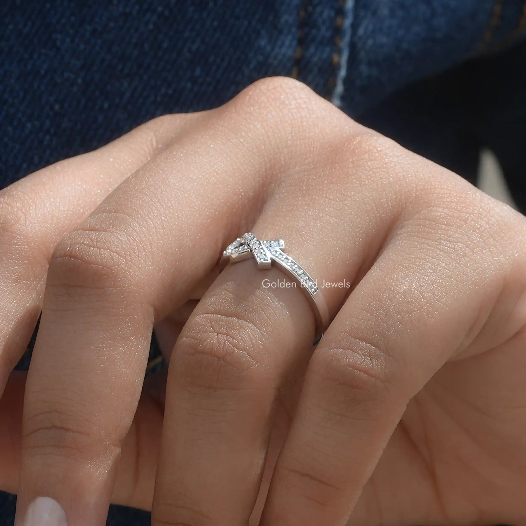 View of Ribbon Style Round Cut Moissanite Ring In Finger