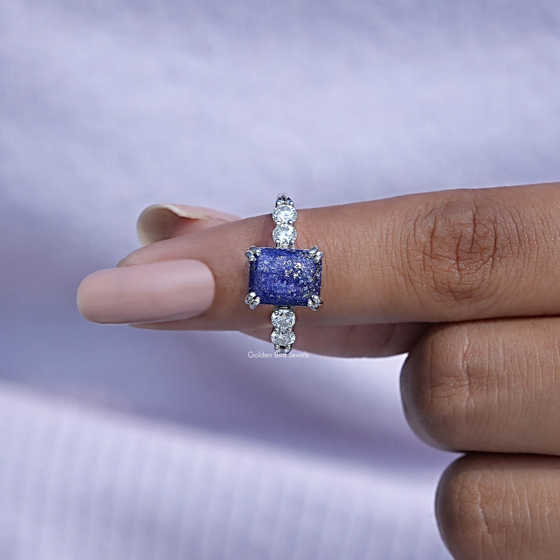 In finger front View of Hidden Halo Emerald Cut Gemstone Ring