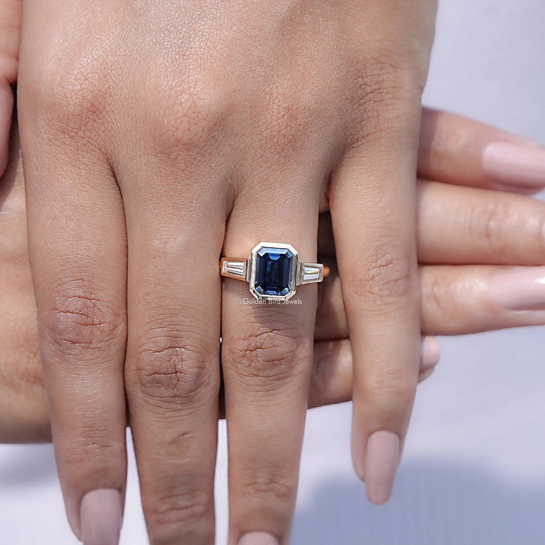 Close view of Emerald Cut Moissanite Three Stone Engagement Ring