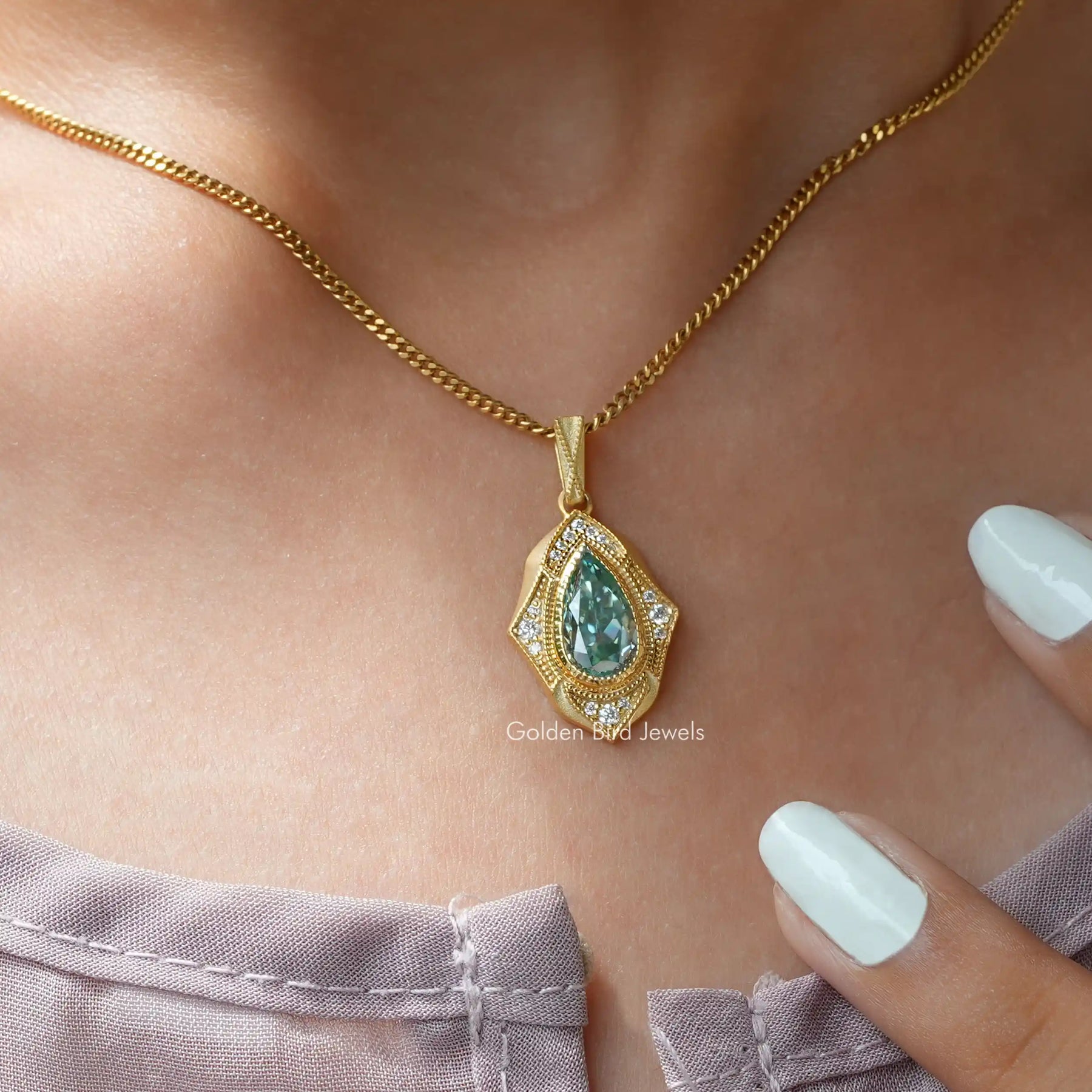 moissanite pendant crafted in yellow gold and round cut side stones