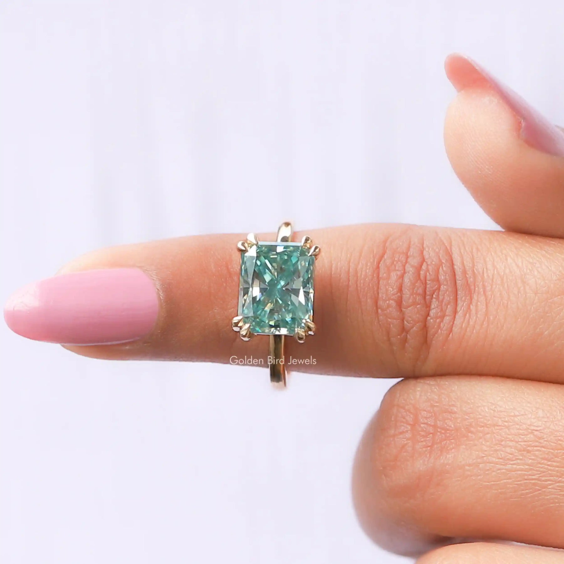 In finger front View of Moissanite Radiant Cut Solitaire Engagement Ring