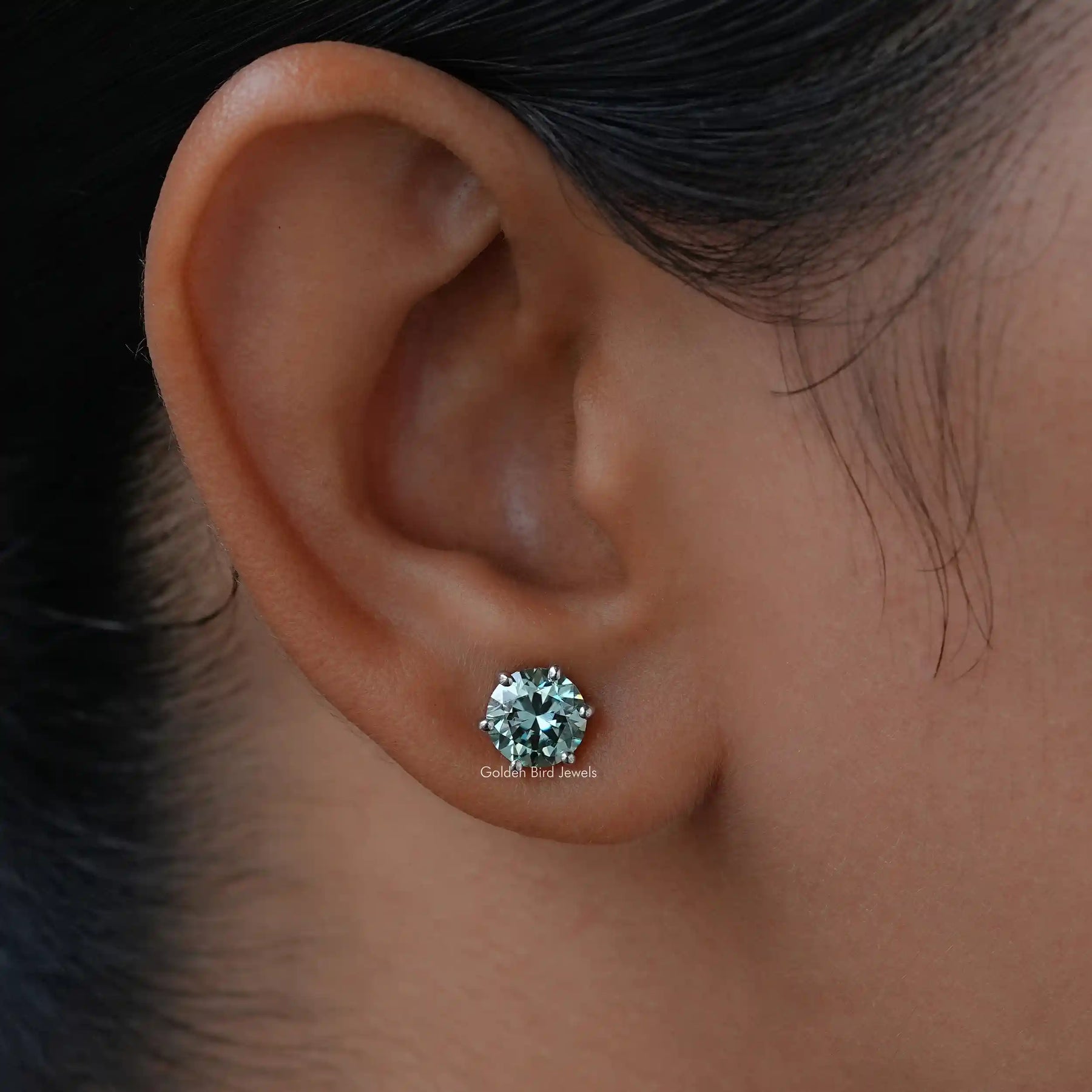 In ear view of round cut moissanite stud earings