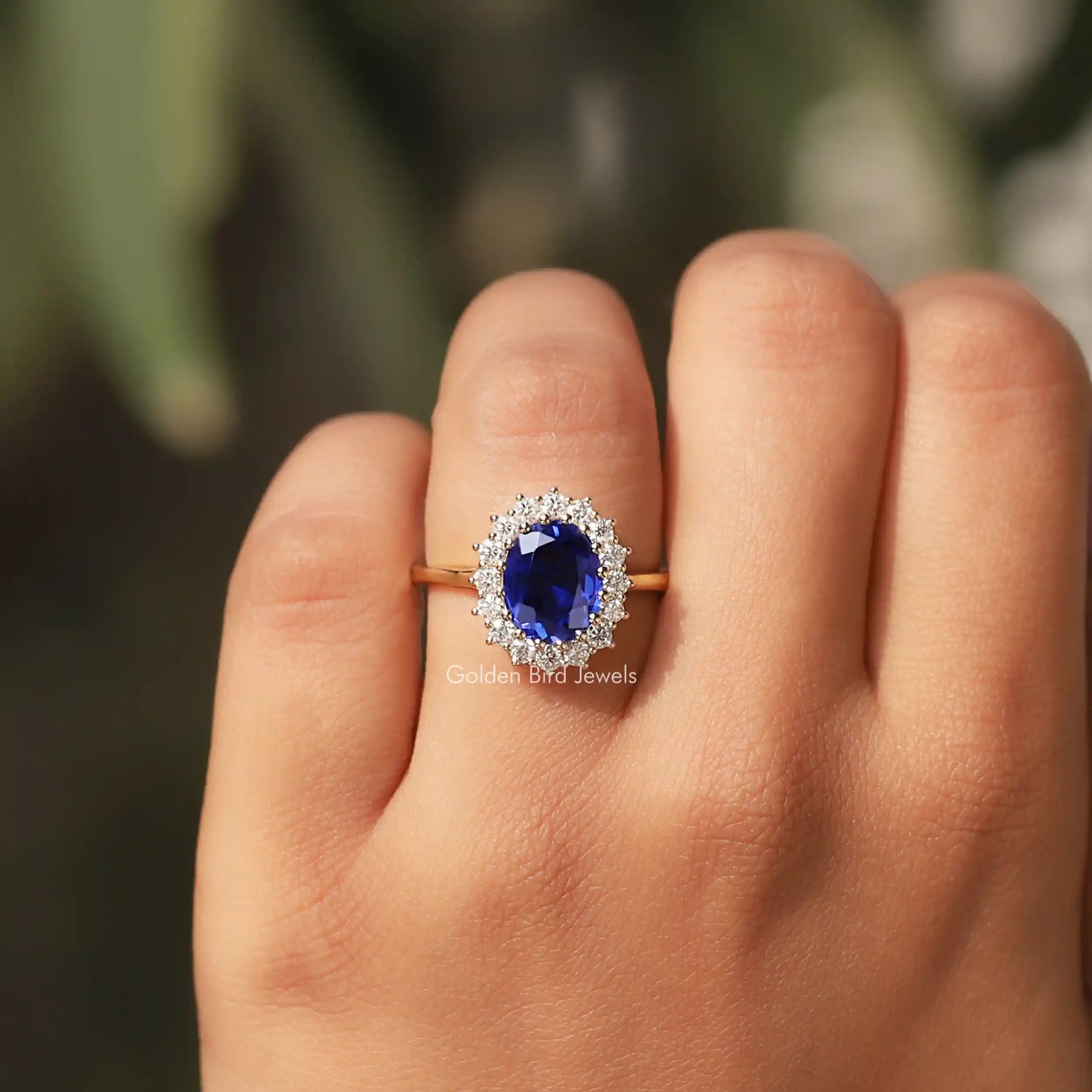 Detailed View Of Oval Cut Halo Gemstone Ring In a finger