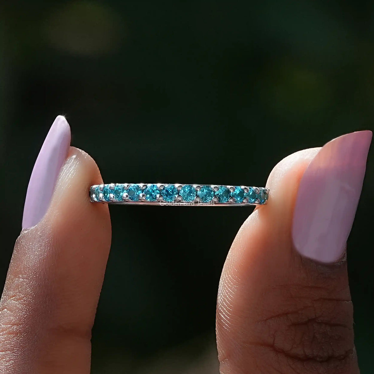 Front view of December Birthstone Blue Topaz Round Eternity Band