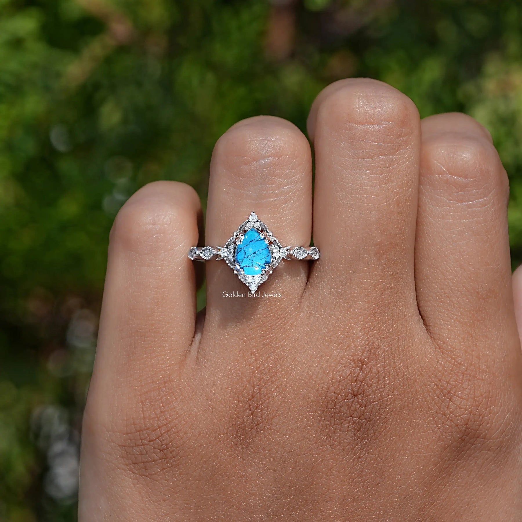 Detailed View of Pear Cut Gemstone Accent Ring In White Gold