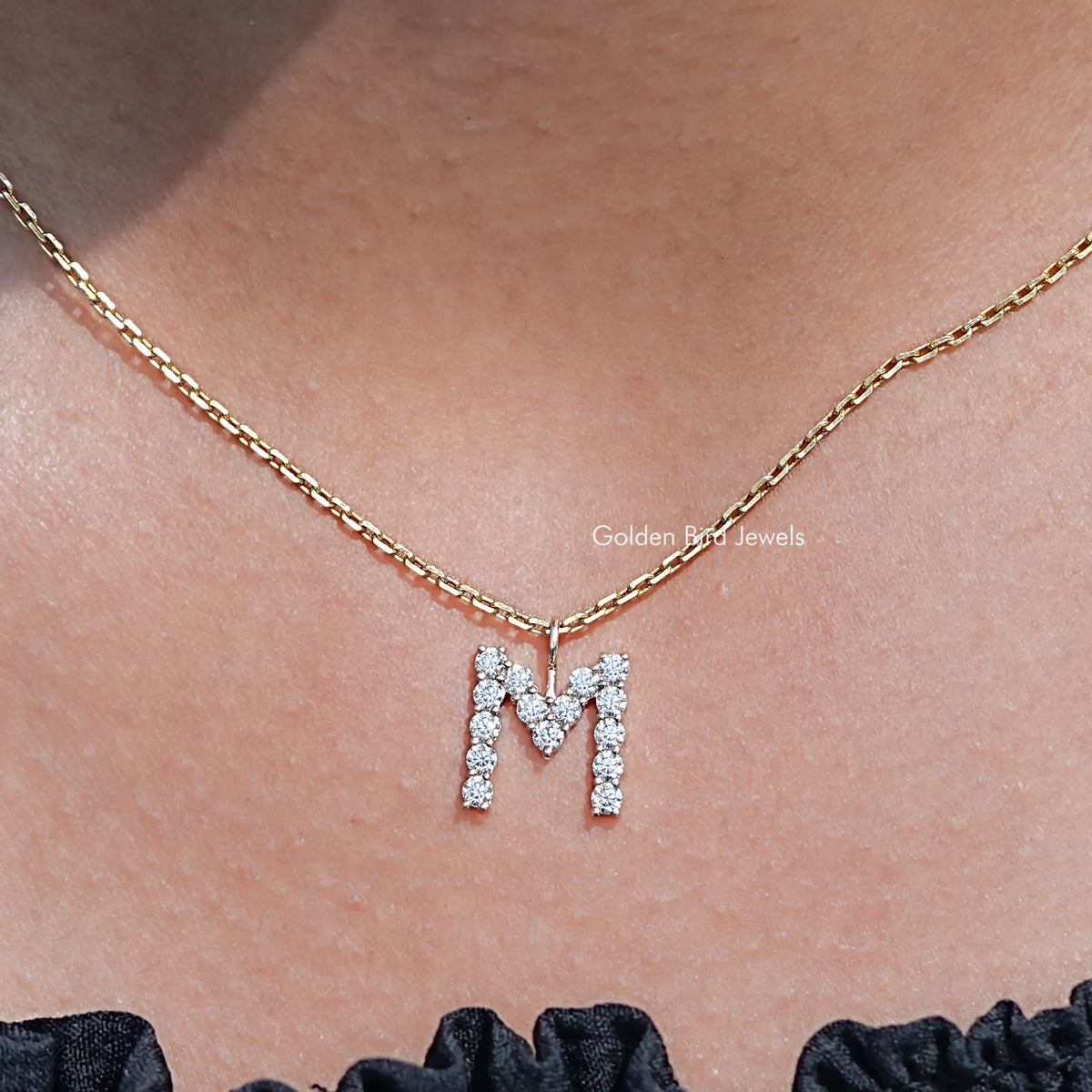 Front view of Colorless Round Moissanite M Letter Pendant