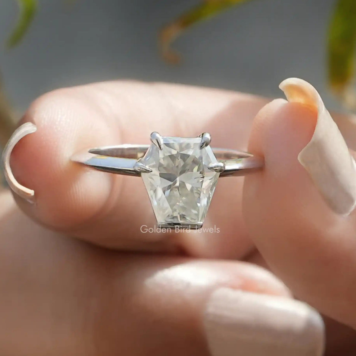 Front view of Calf's Head Cut Moissanite Solitaire Ring in two fingers