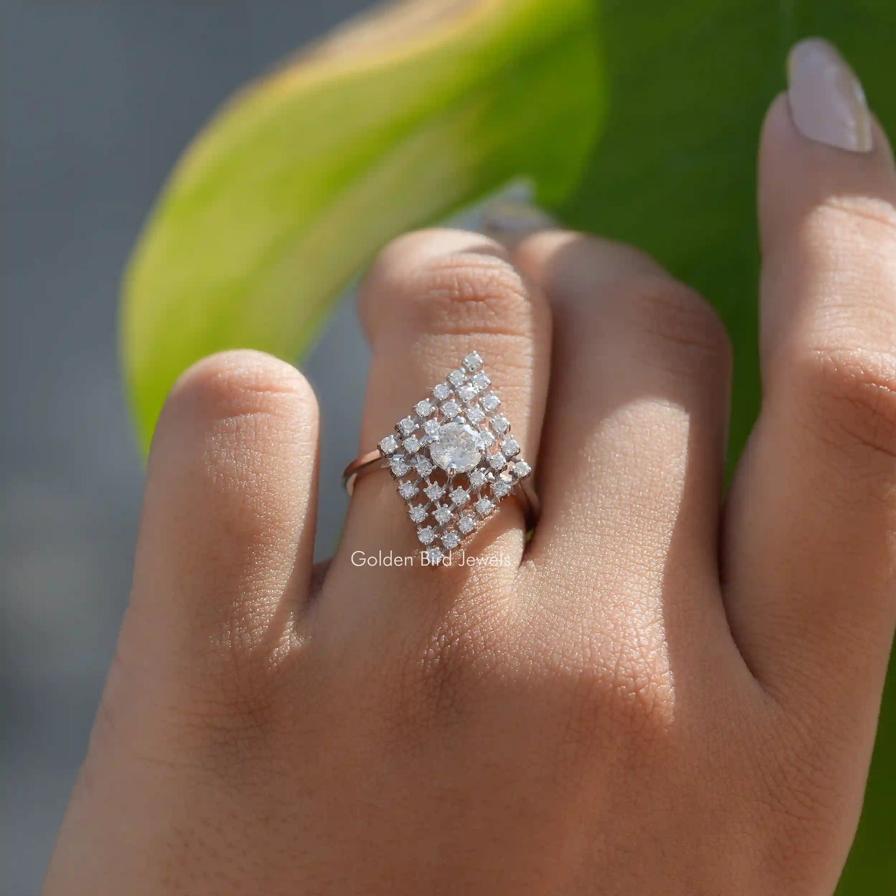 Close-Up View Of Portuguese Cut Moissanite Antique Engagement Ring on a finger