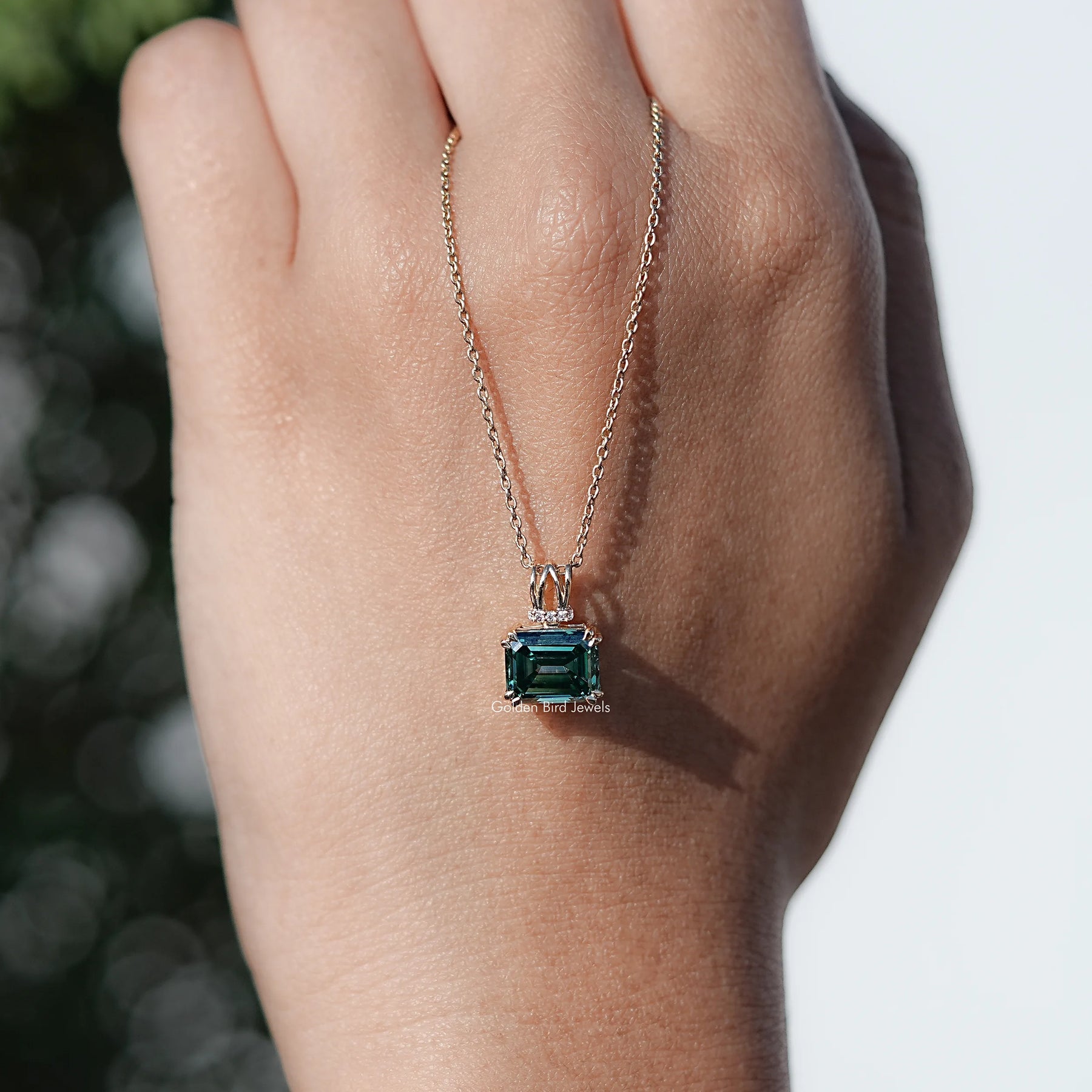 Close View Of Emerald cut moissanite pendant in Secure Setting