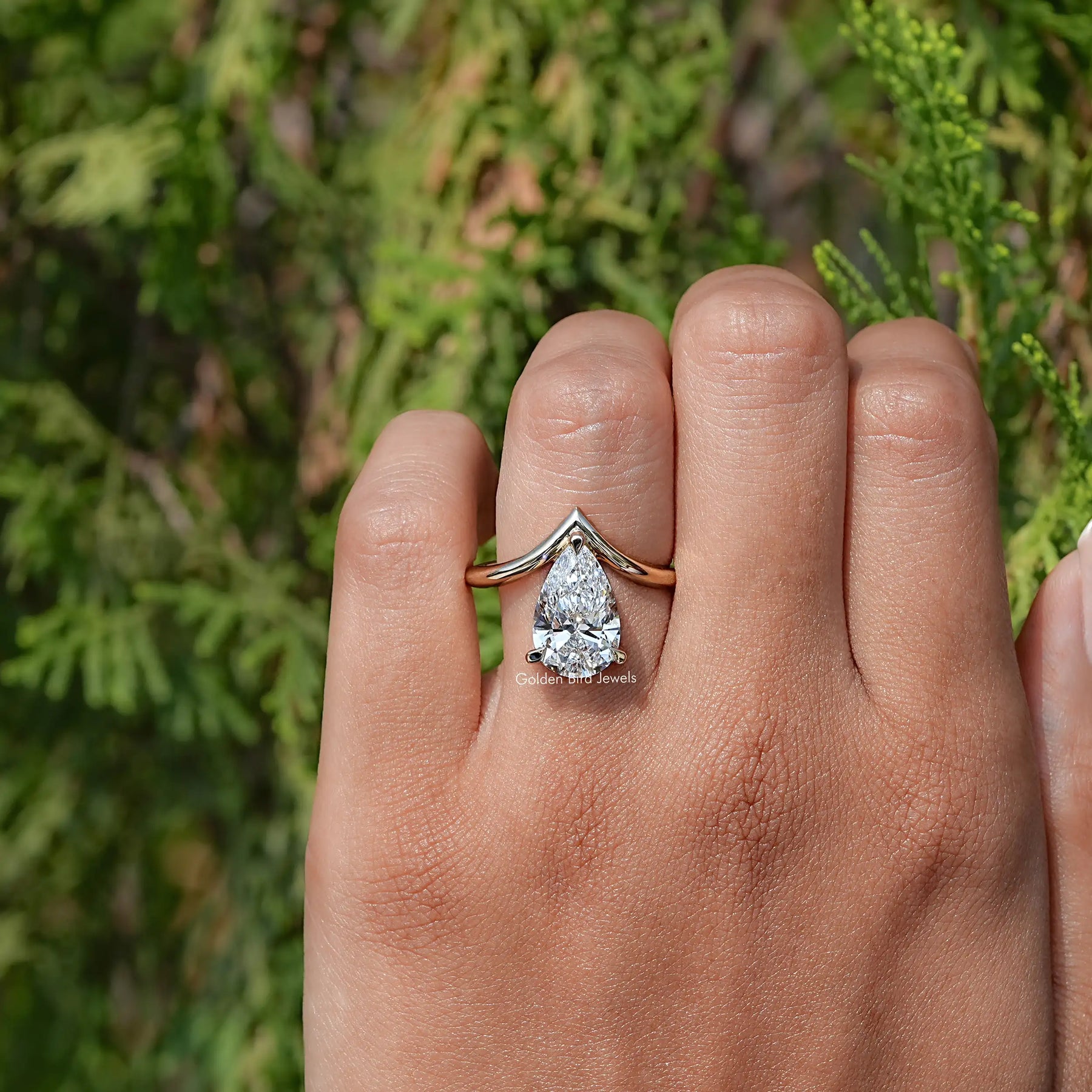 View of Pear Cut Curved V Shaped Shank Solitaire Ring In Yellow Gold