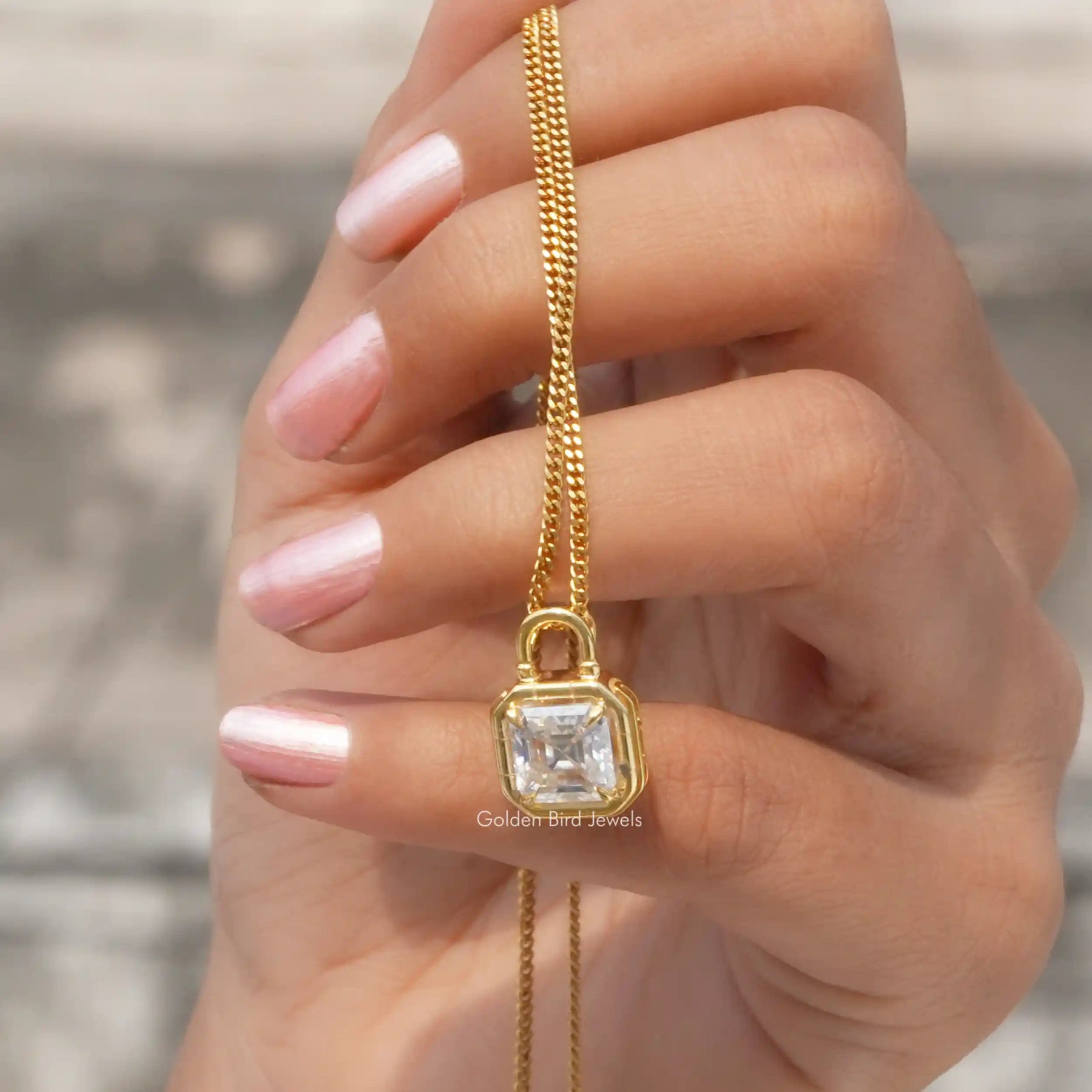 In hand showing view of moissanite pendant