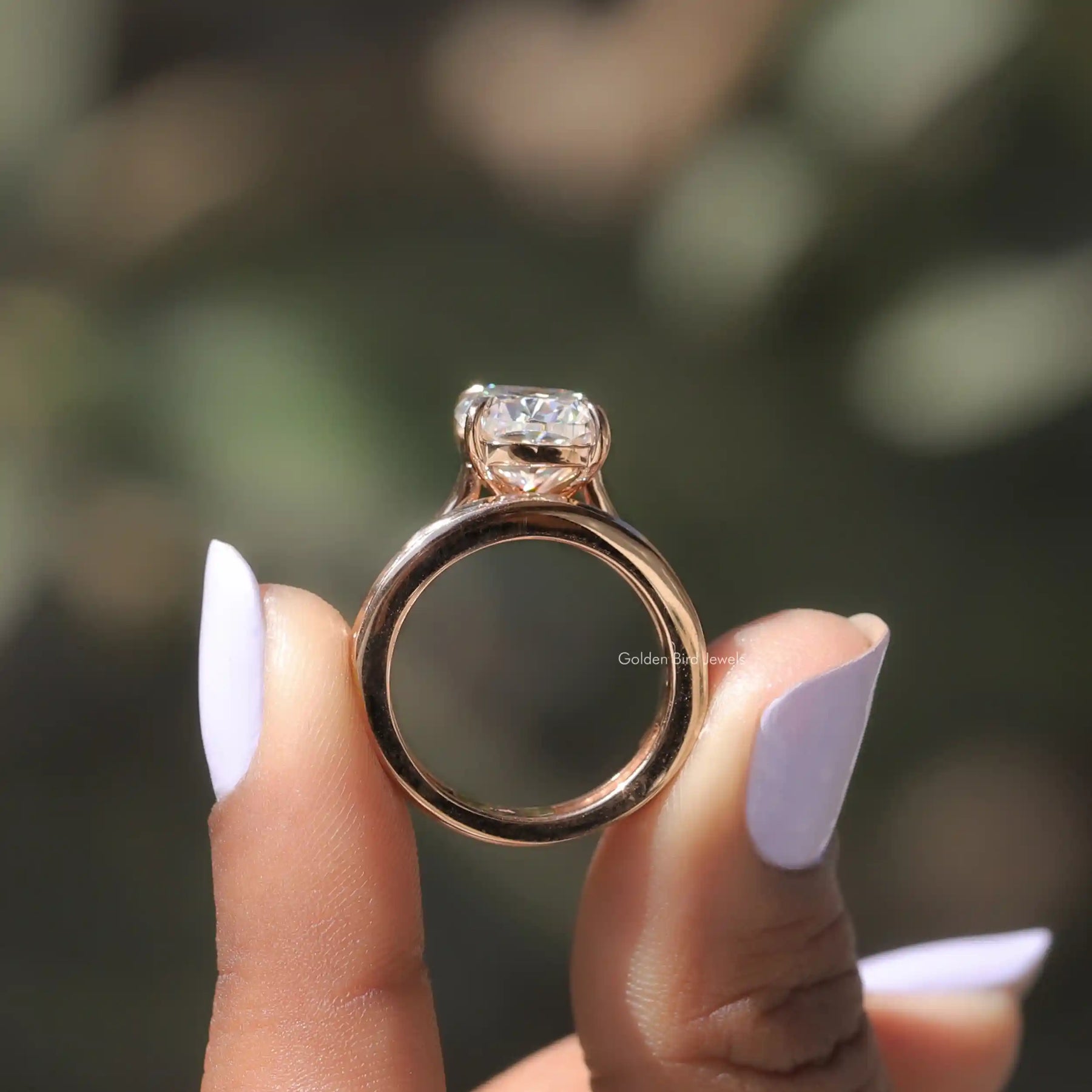 Back View of Cushion Cut Moissanite Bridal Ring Set In two fingers