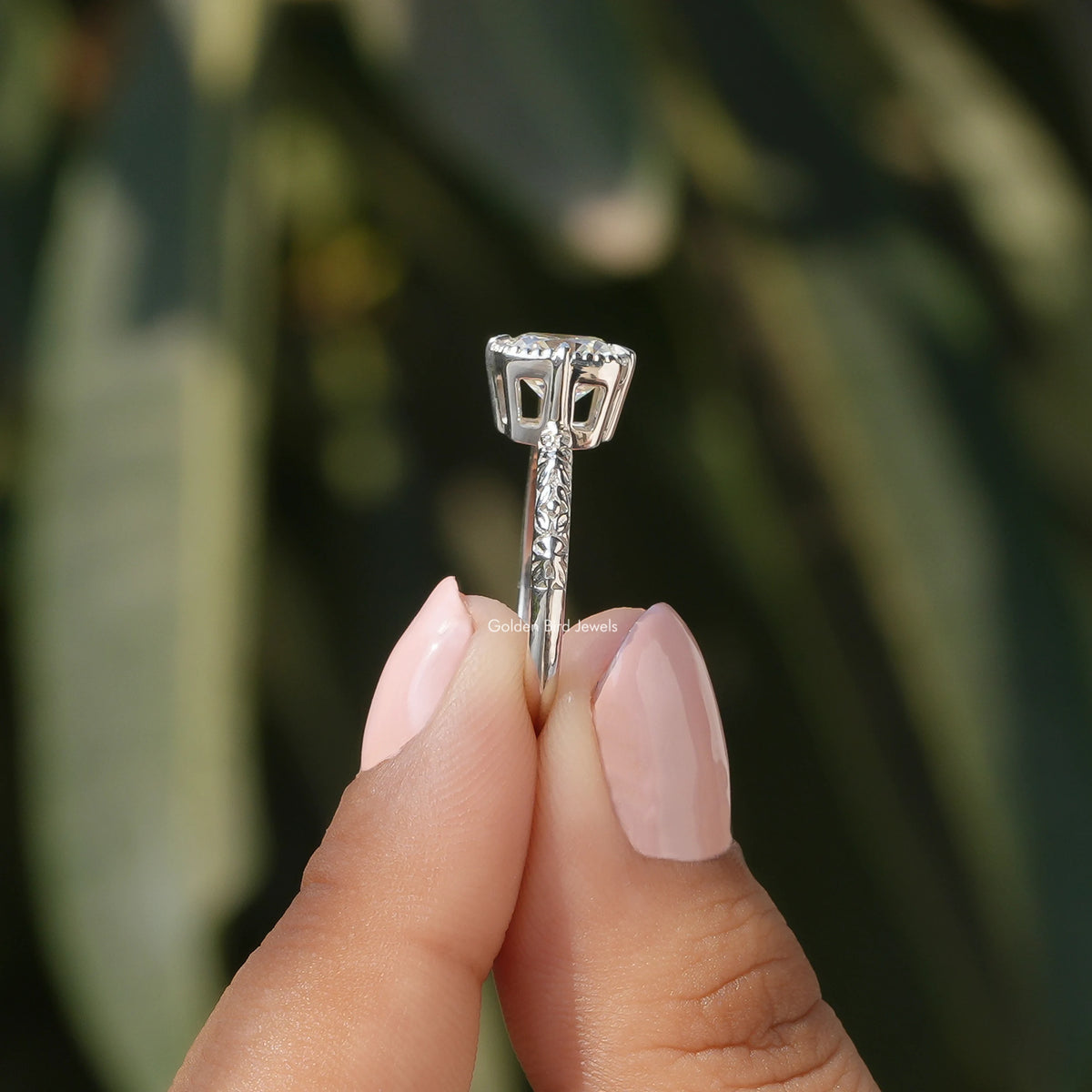 Side View of Peruzzi Cut Moissanite Solitaire Ring In two fingers