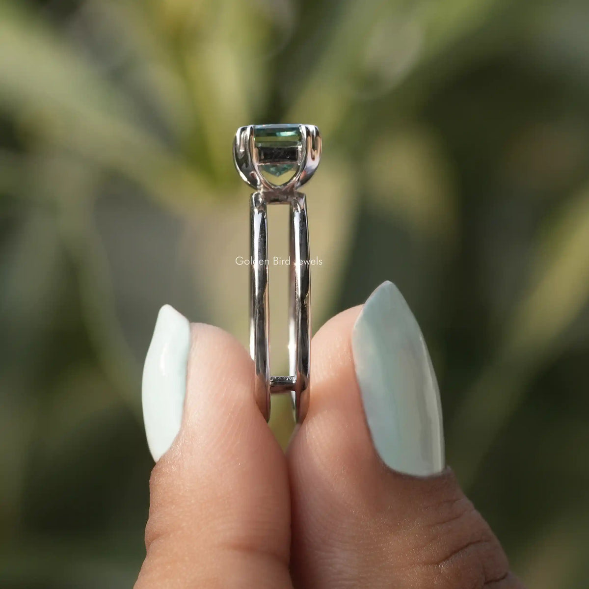 Side View of Double Prong Criss Cut Moissanite Ring In two fingers