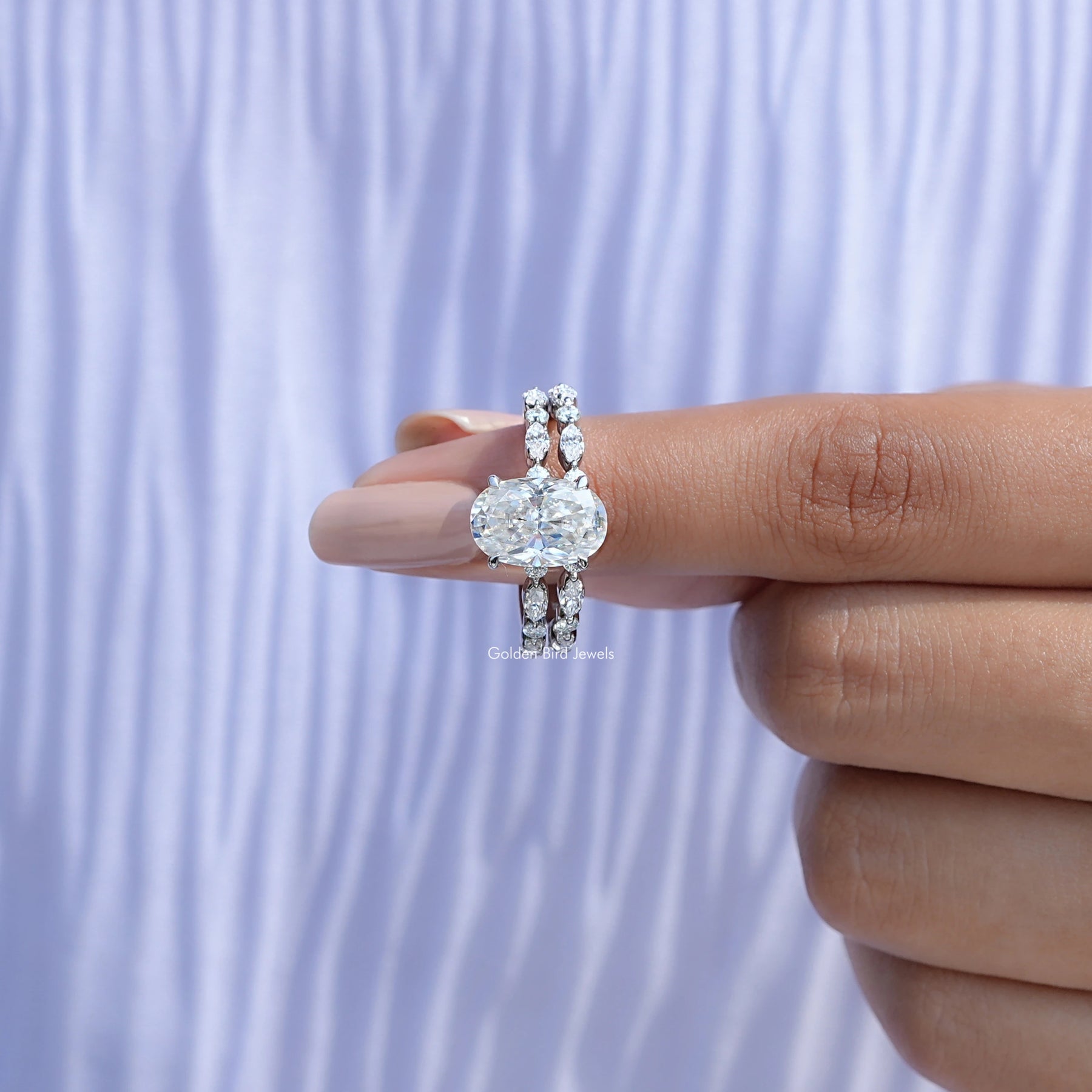In finger front view of Crushed ice Oval Cut moissanite Bridal Set ring in unique shape