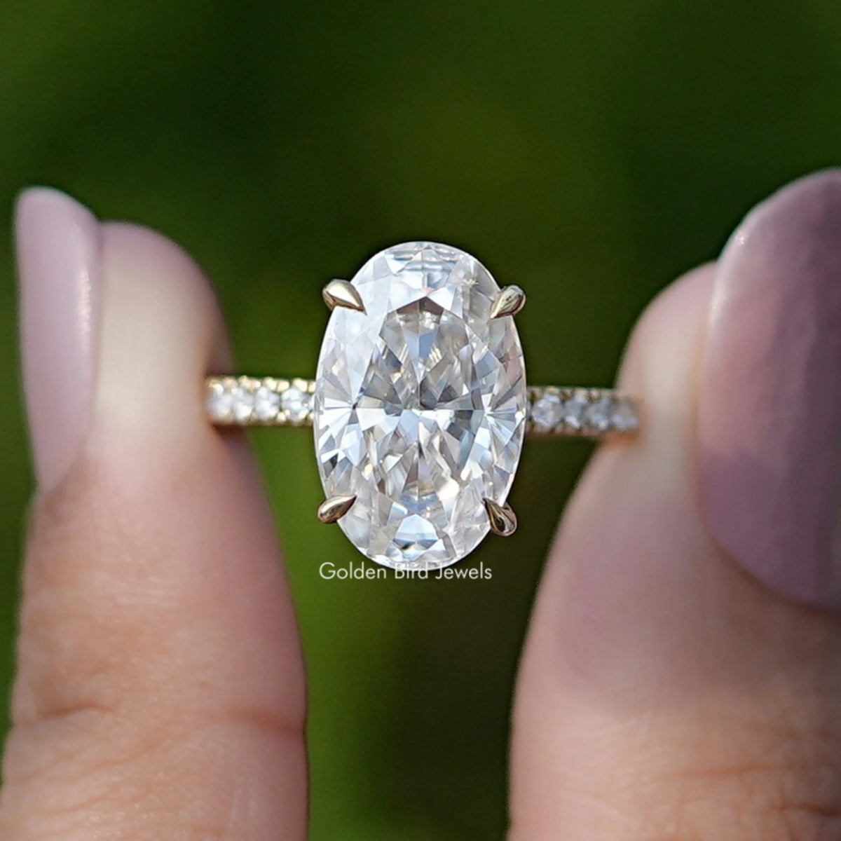 Front View of Oval Cut Moissanite Solitaire Ring In two Fingers