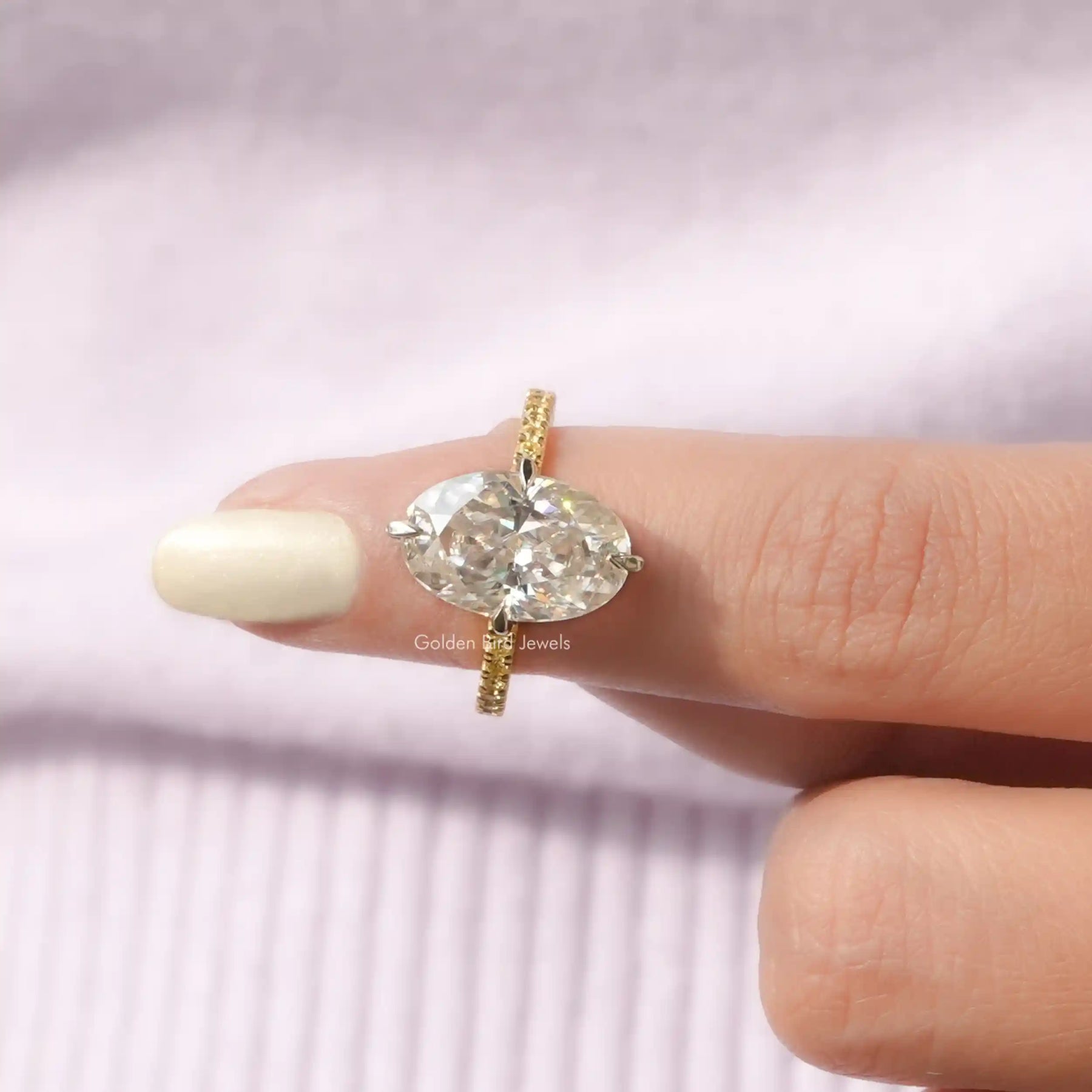In finger front View of Crushed Ice Oval Cut Ring With Round Cut Stones