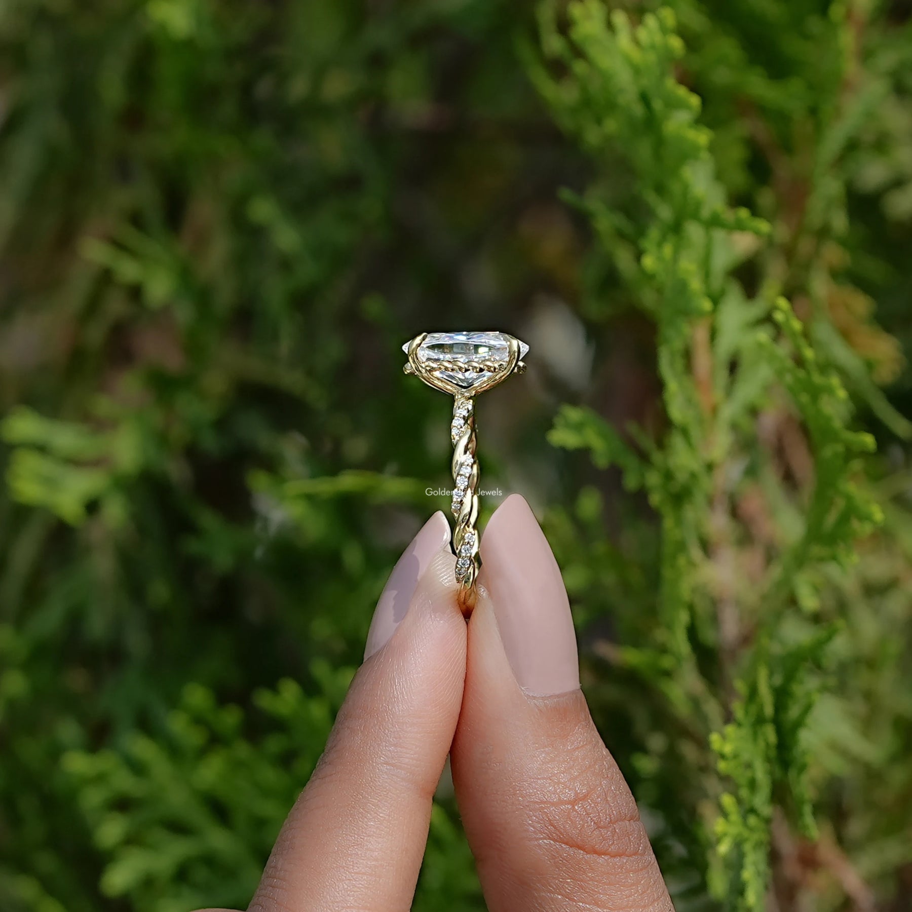 Side View of Oval Cut Moissanite Twist Shank Ring In two fingers