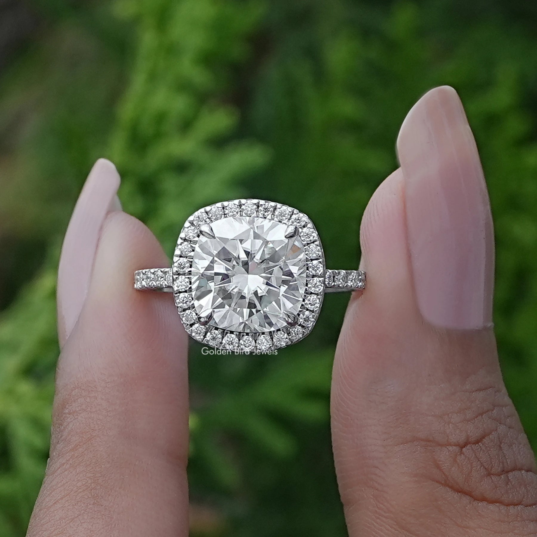 Front View of Cushion Cut Lab Diamond Halo Engagement Ring In two Fingers