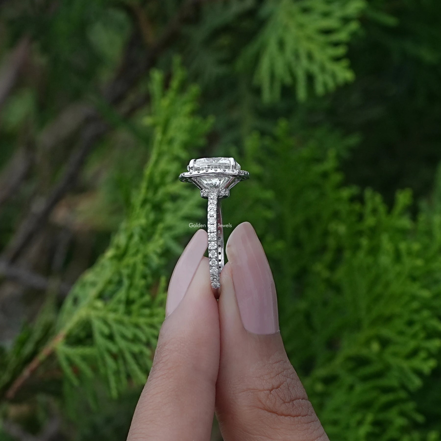 Side View of Cushion Cut Lab Diamond Halo Engagement Ring In two fingers
