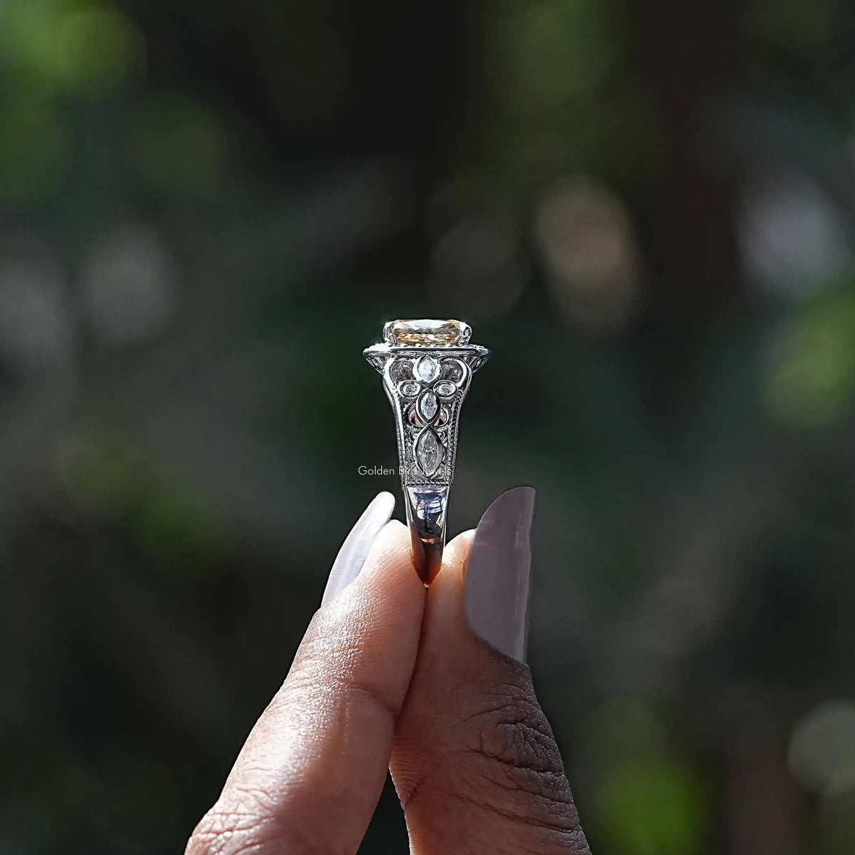 Side View of Cushion And Marquise Cut Moissanite Ring In two fingers
