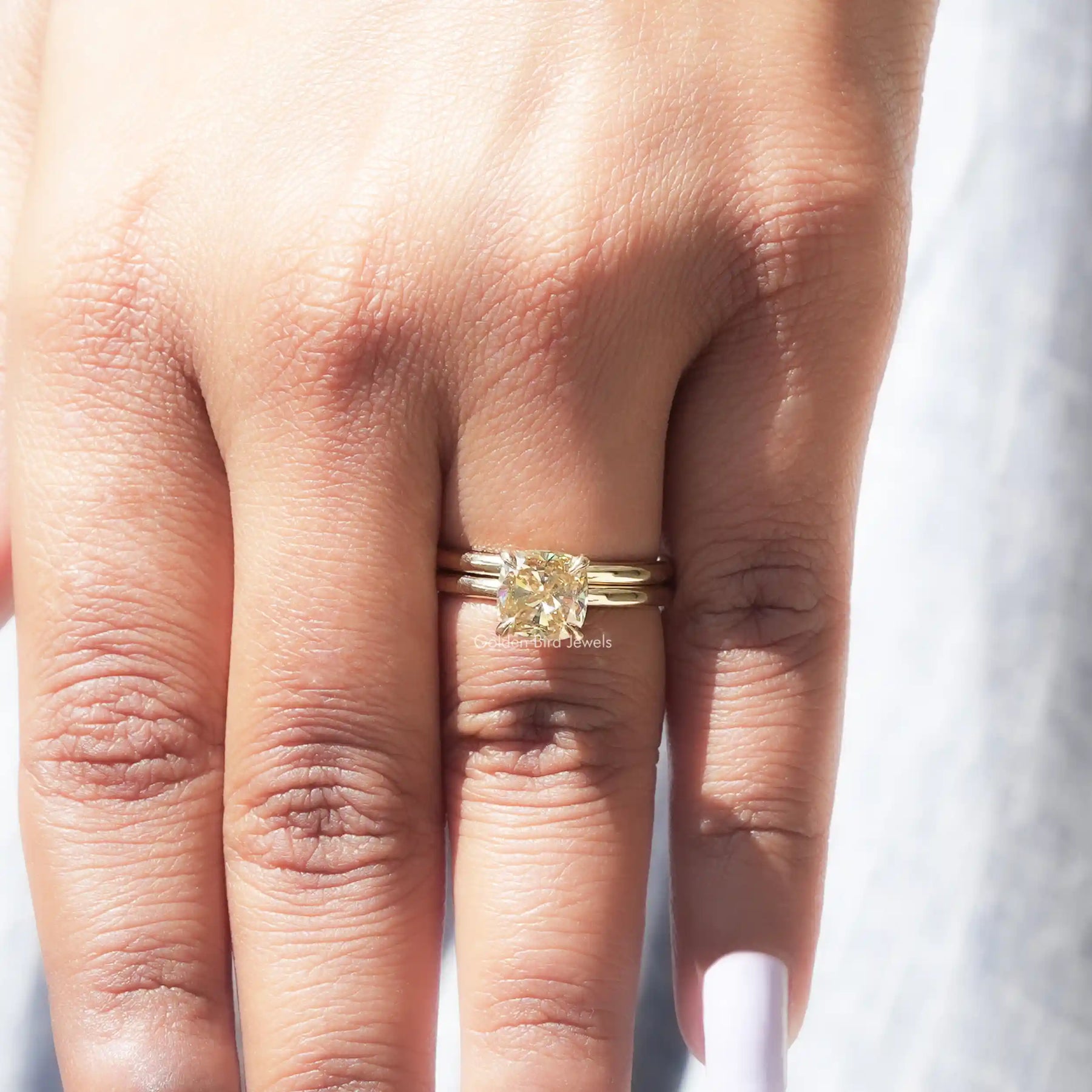 Detailed view of cushion cut moissanite ring in prongs seeting