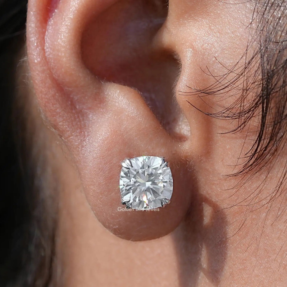 In ear view of moissanite emerald Cut Stud Earrings