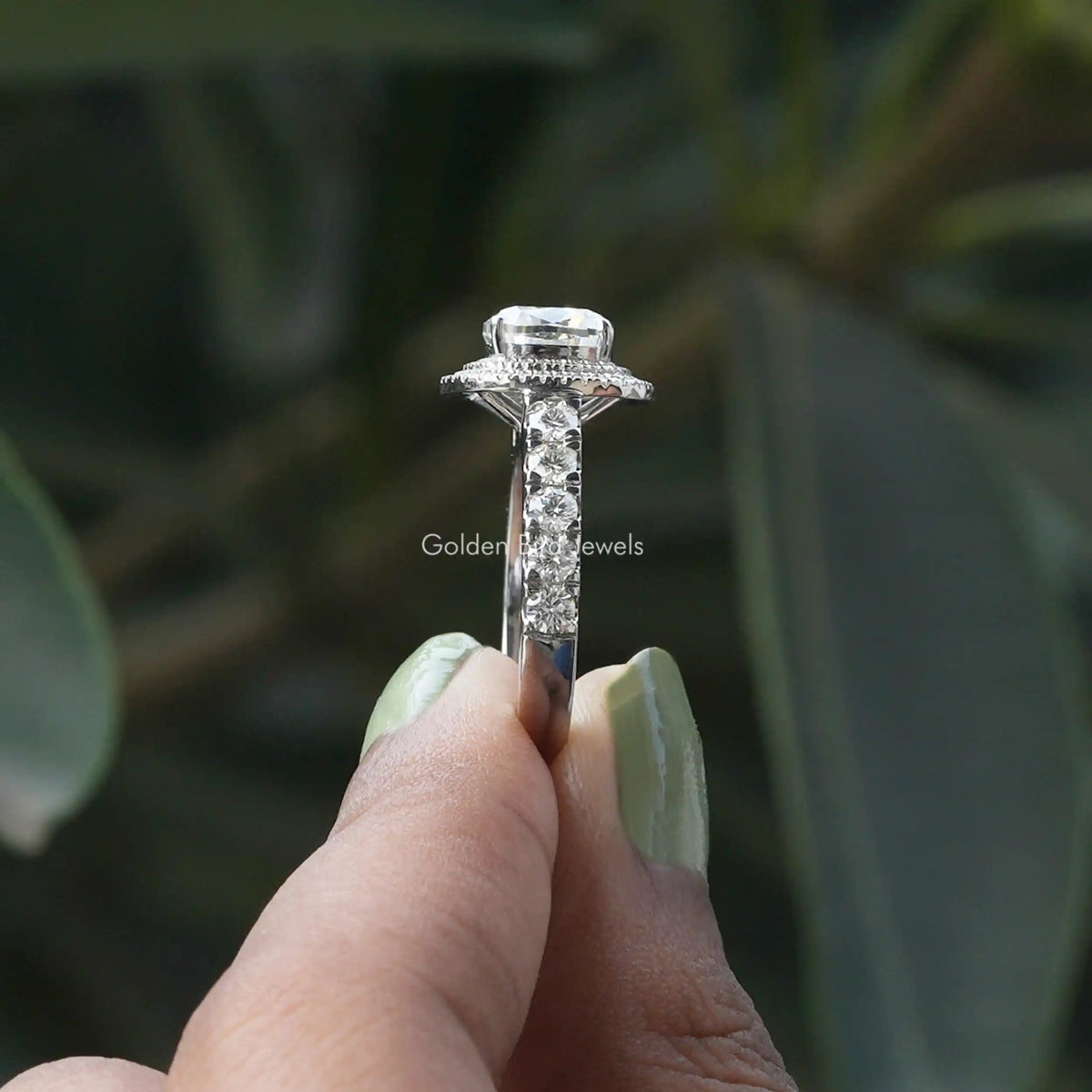Side View of Cushion Cut Moissanite Ring In two fingers