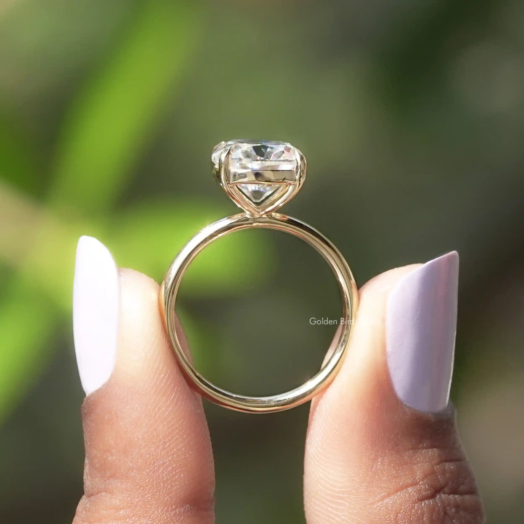 Back View of Cushion Cut Moissanite Ring In two fingers