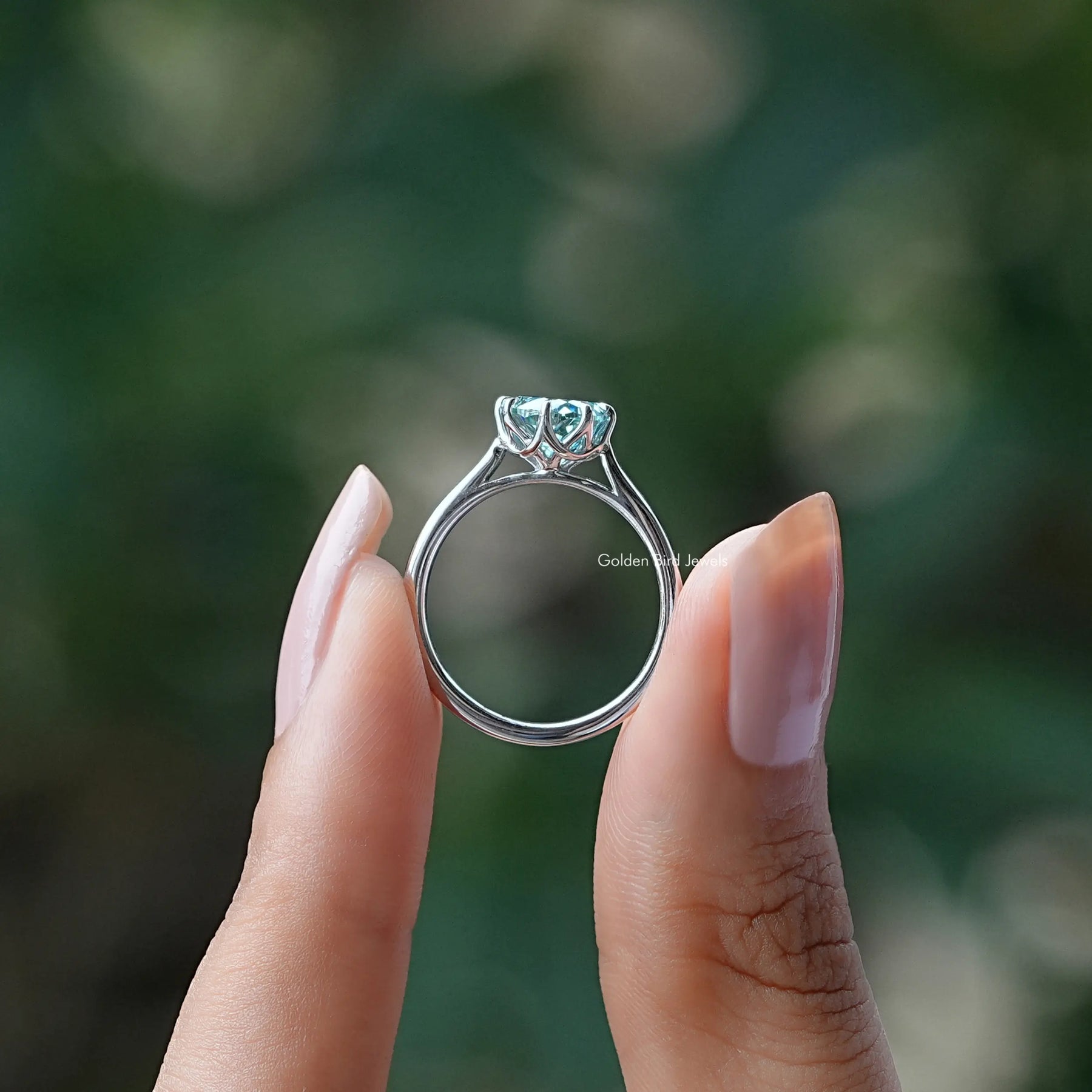 Back View of Moissanite Portuguese Cut Ring In two fingers