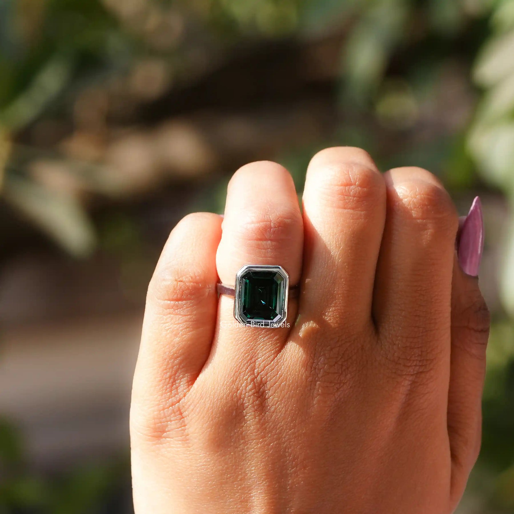 View of Green Emerald Cut Solitaire Ring In White Gold