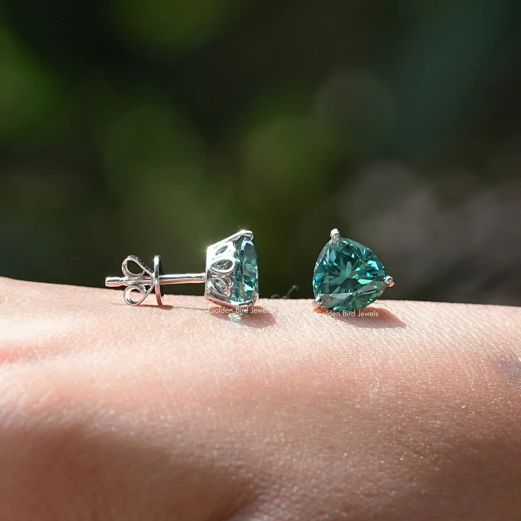 Front and back view of dark green moissanite ear studs