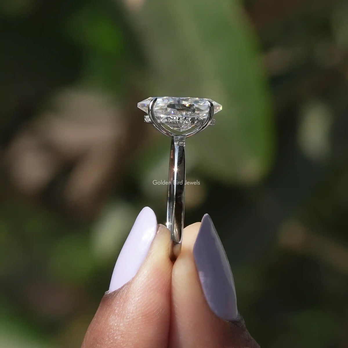 Side View of Dutch Marquise Cut Moissanite Engagement Ring In two fingers