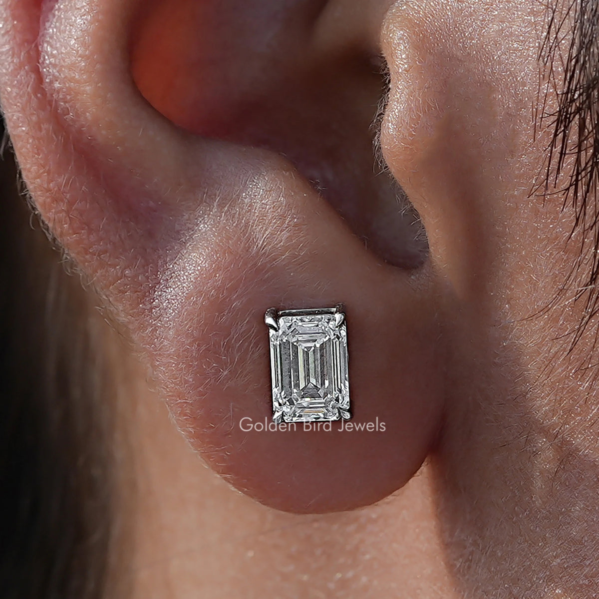 Close Up View Of Emerald Cut Diamond Solitaire Stud Earrings