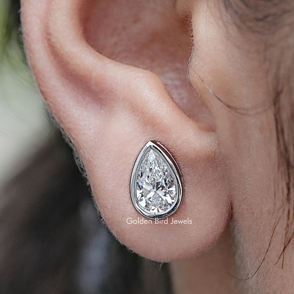 Close up view of Pear Shaped Lab Diamond Bezel Set Stud Earrings