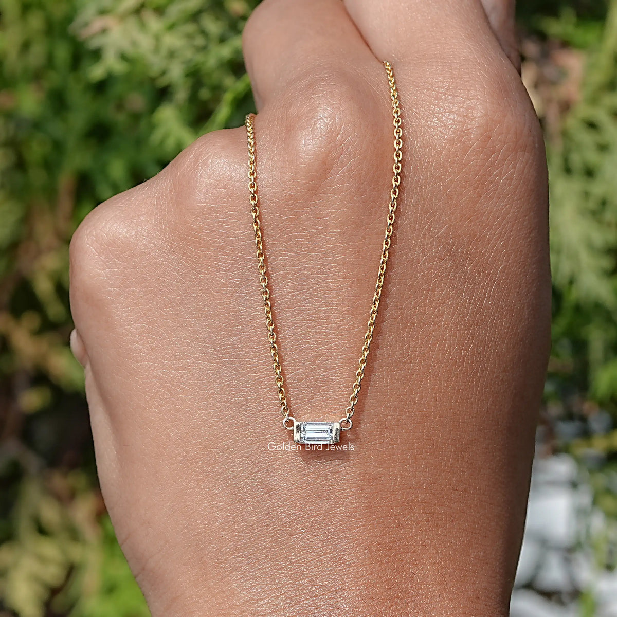 In Hand Holding the Baguette Cut Lab Diamond Pendant