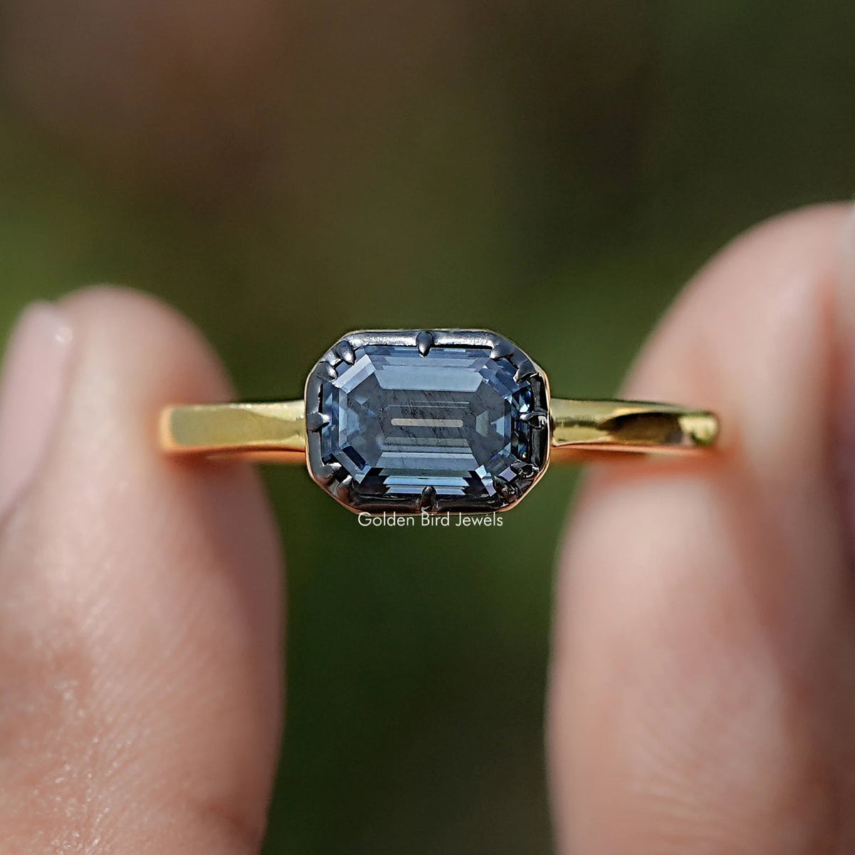 Front view of East West Emerald Cut Moissanite Solitaire Ring