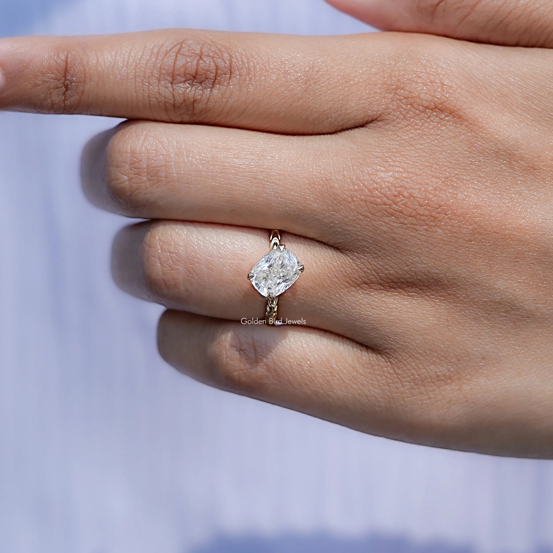 View of solitaire Cushion Cut Moissanite ring in prongs setting