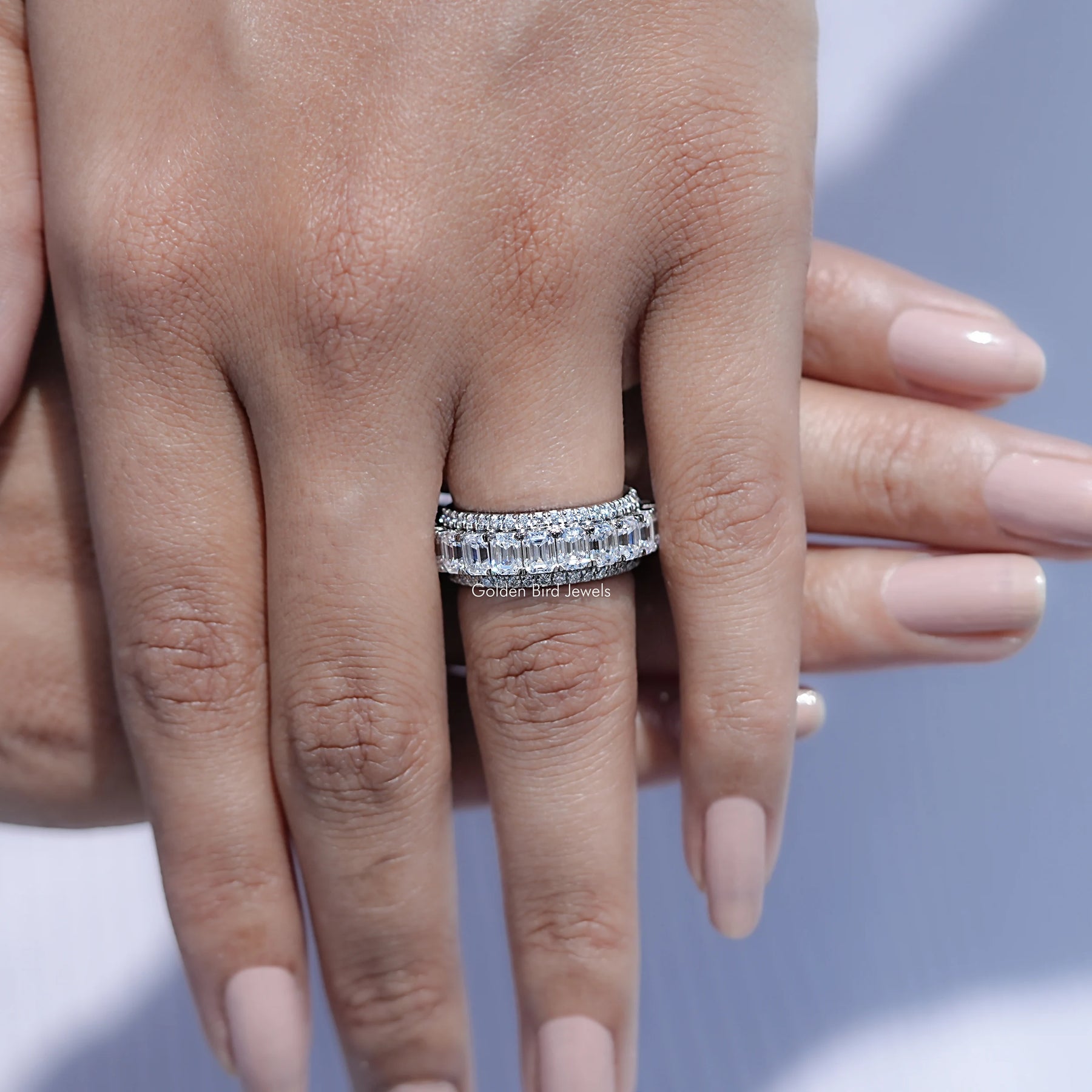 View of Emerald and Round Cut moissanite three row band