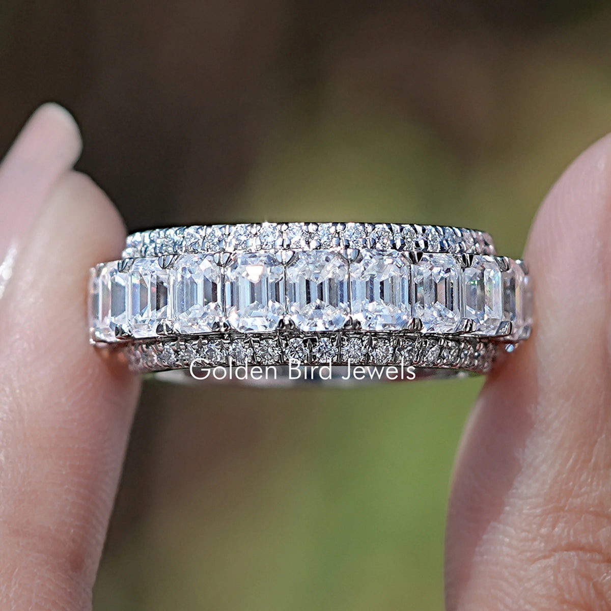 Front view of Emerald And Round Moissanite Three Row Wedding Band